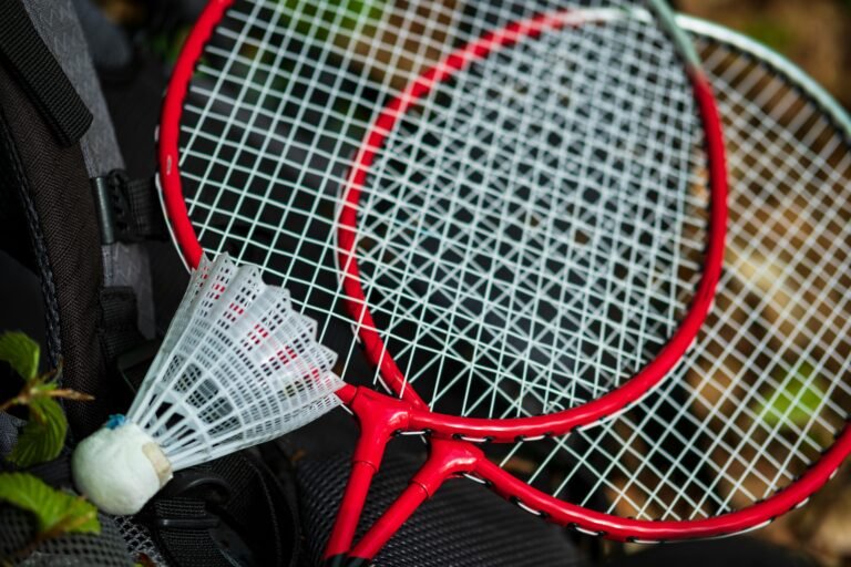 Shuttlecock and badminton racket. Active games in the park in the fresh air.